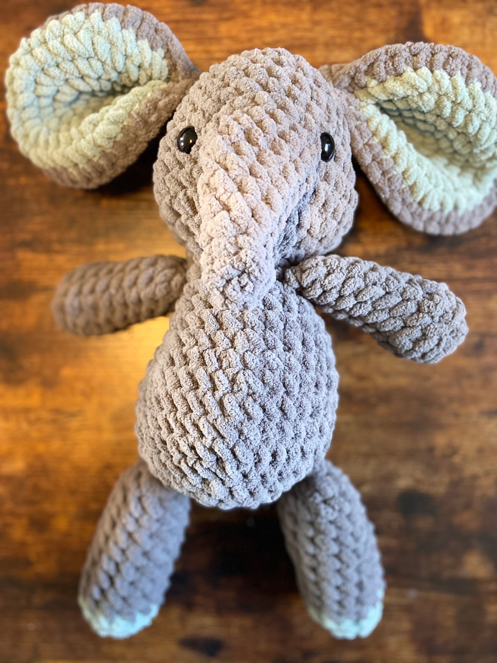 Crochet elephant: A handmade amigurumi elephant with gray body, floppy ears, and a gentle expression, ideal for cuddling and decorating.