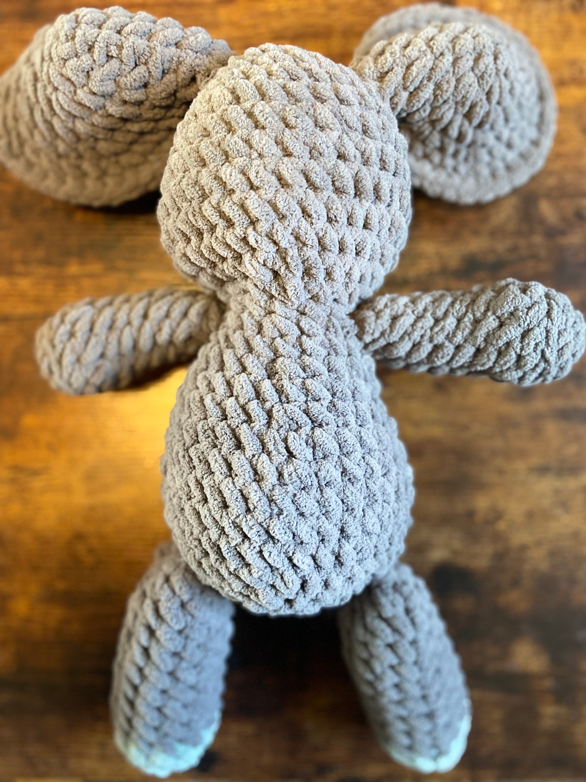 Crochet elephant toy: A cute and soft amigurumi elephant with gray body, floppy ears, and a playful expression, perfect for playtime and snuggling.