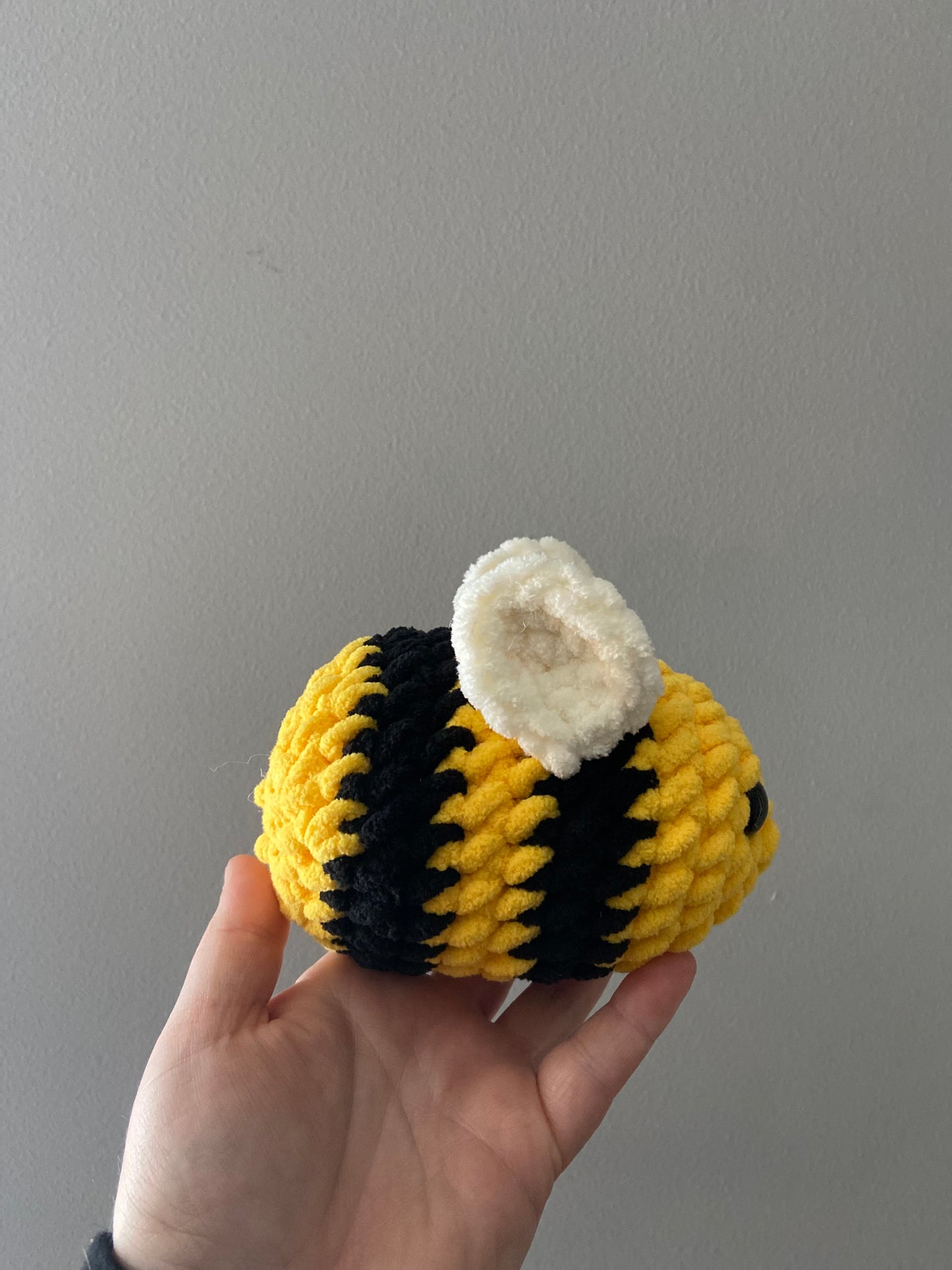 Baby bee crochet gift: A small crochet bee with yellow and black stripes, soft wings, and a sweet smile, perfect for gifting to a newborn or young child.