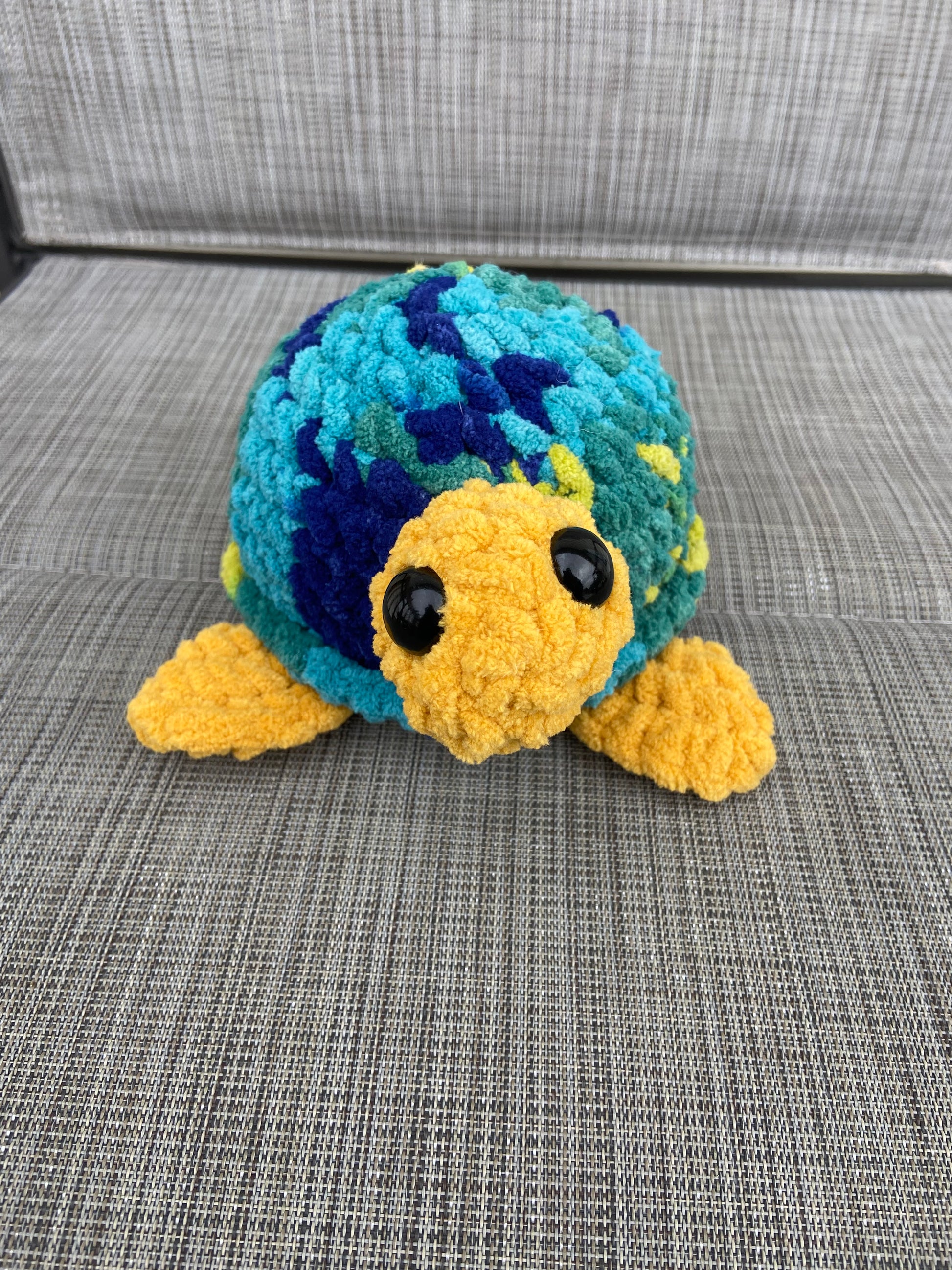 Small crocheted turtle figurine with intricate shell design
